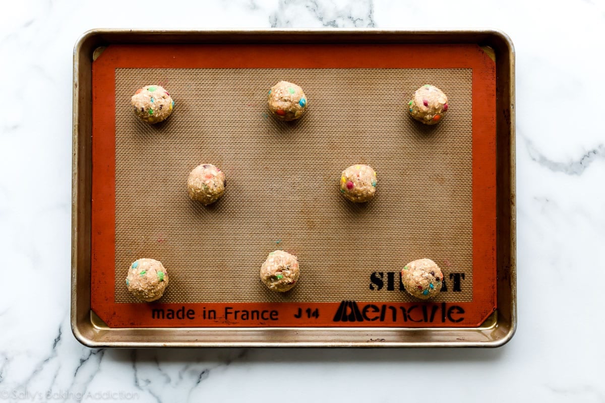 oatmeal M&M cookie dough balls on a baking sheet