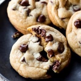 warm chocolate chip cookies on black plate