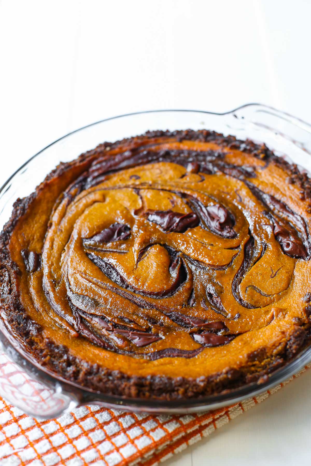 Nutella swirled pumpkin pie in a glass baking dish