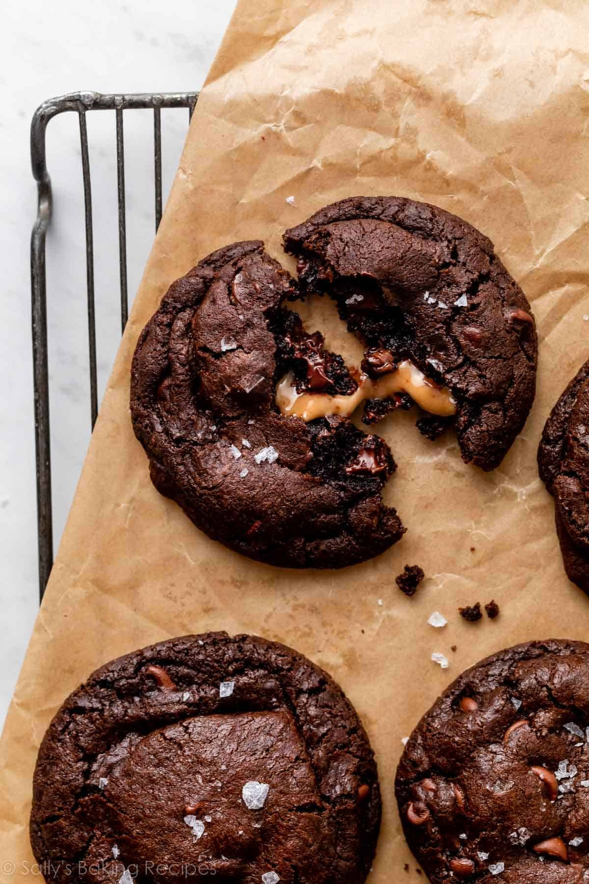 salted caramel dark chocolate cookies on brown parchment paper.