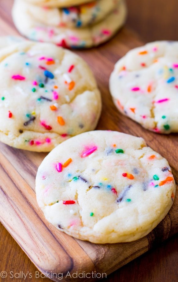 funfetti sugar cookies on a wood board