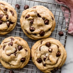 6 chocolate chip cookies on silver wire cooling rack