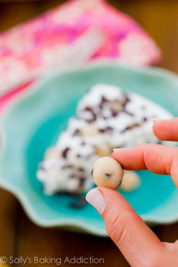 hand holding a mini cookie dough ball