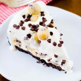 slice of chocolate chip cookie dough ice cream pie on a white plate