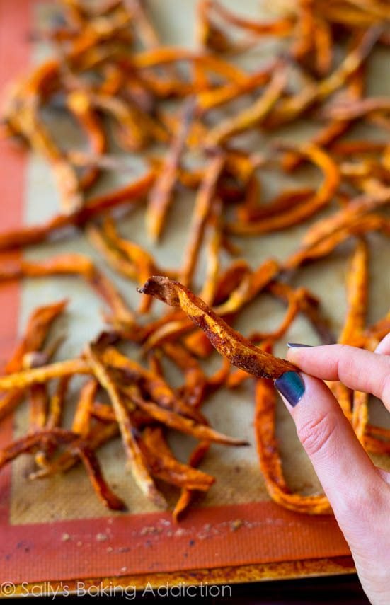 hand holding a sweet potato fry