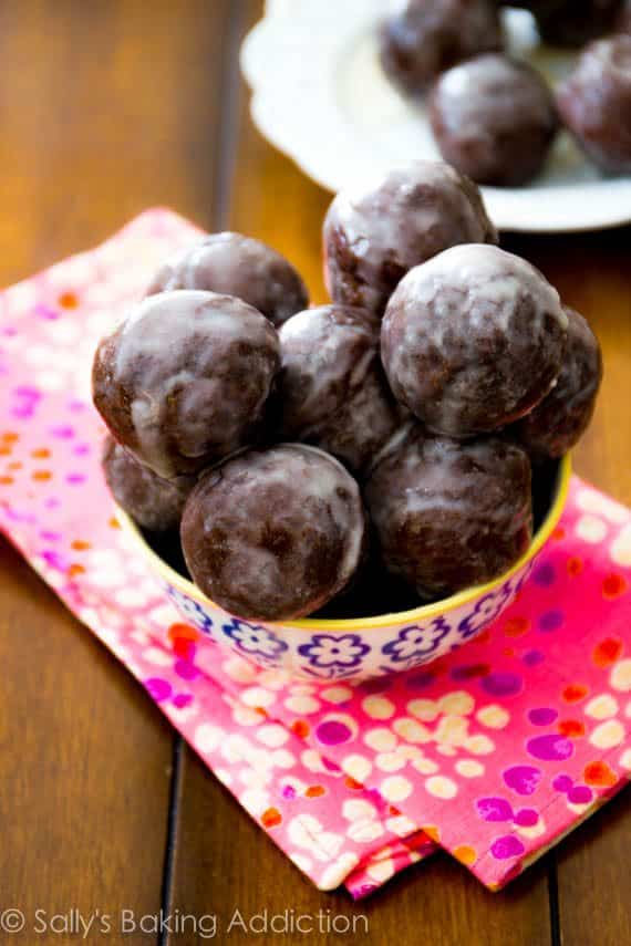 glazed chocolate donut holes in a colorful bowl