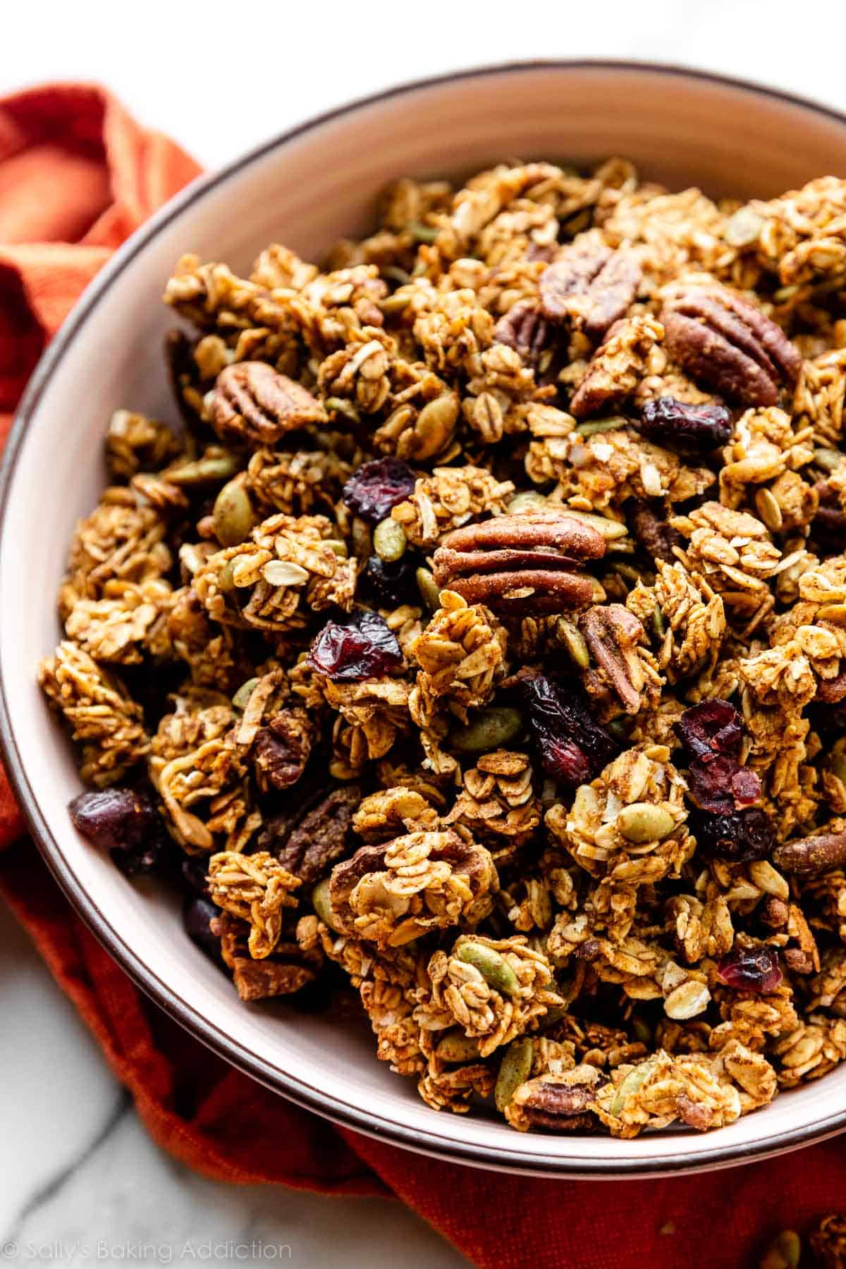 pink bowl of pumpkin spice granola clusters.