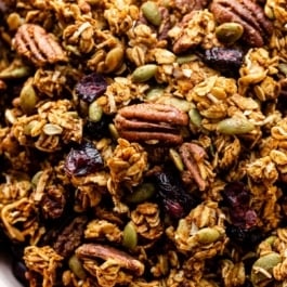 close-up photo of pumpkin spice granola with pecans and dried cranberries.