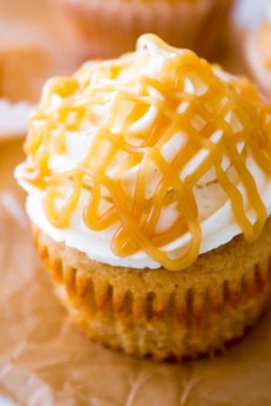 brown sugar cupcake topped with vanilla frosting and butterscotch drizzle