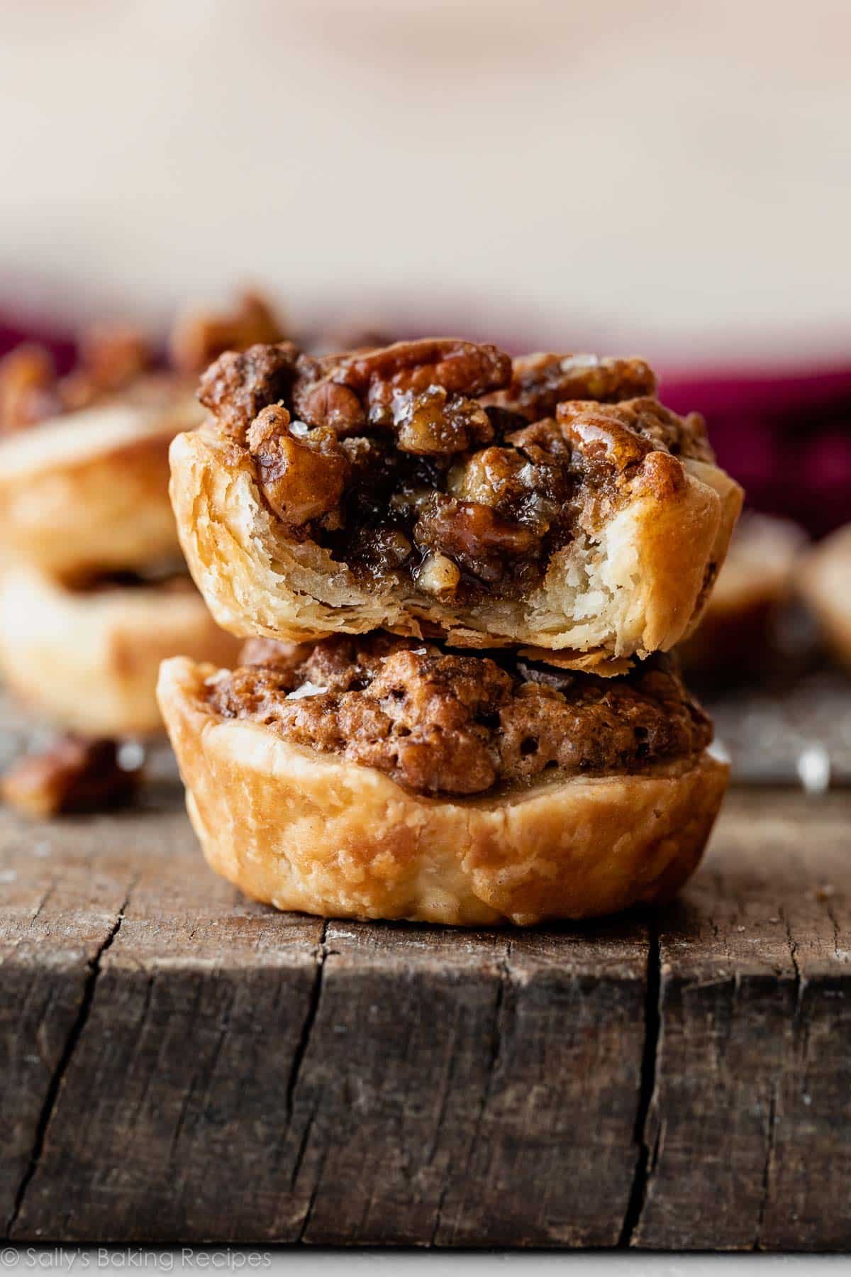 stack of mini pecan pies with gooey filling.