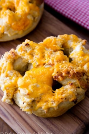 soft pretzels topped with cheesy crab dip on a wood board