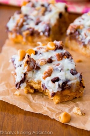 ultimate magic cookie bars with a bite taken from one