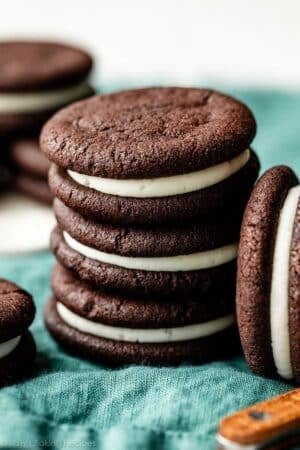 stack of 3 homemade Oreos on blue linen.