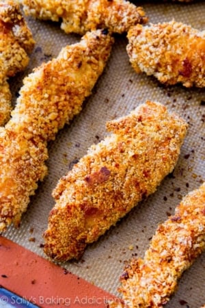 baked chicken fingers on a silpat baking mat