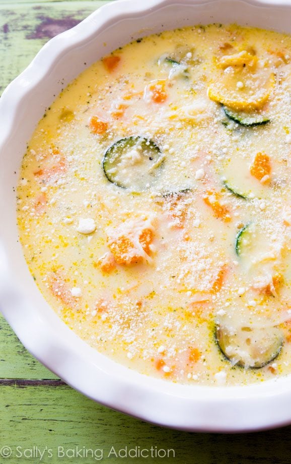 crustless veggie quiche in a white baking dish before baking