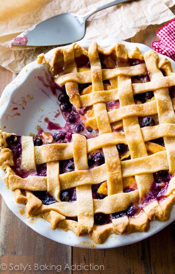 blueberry peach pie in a white pie dish