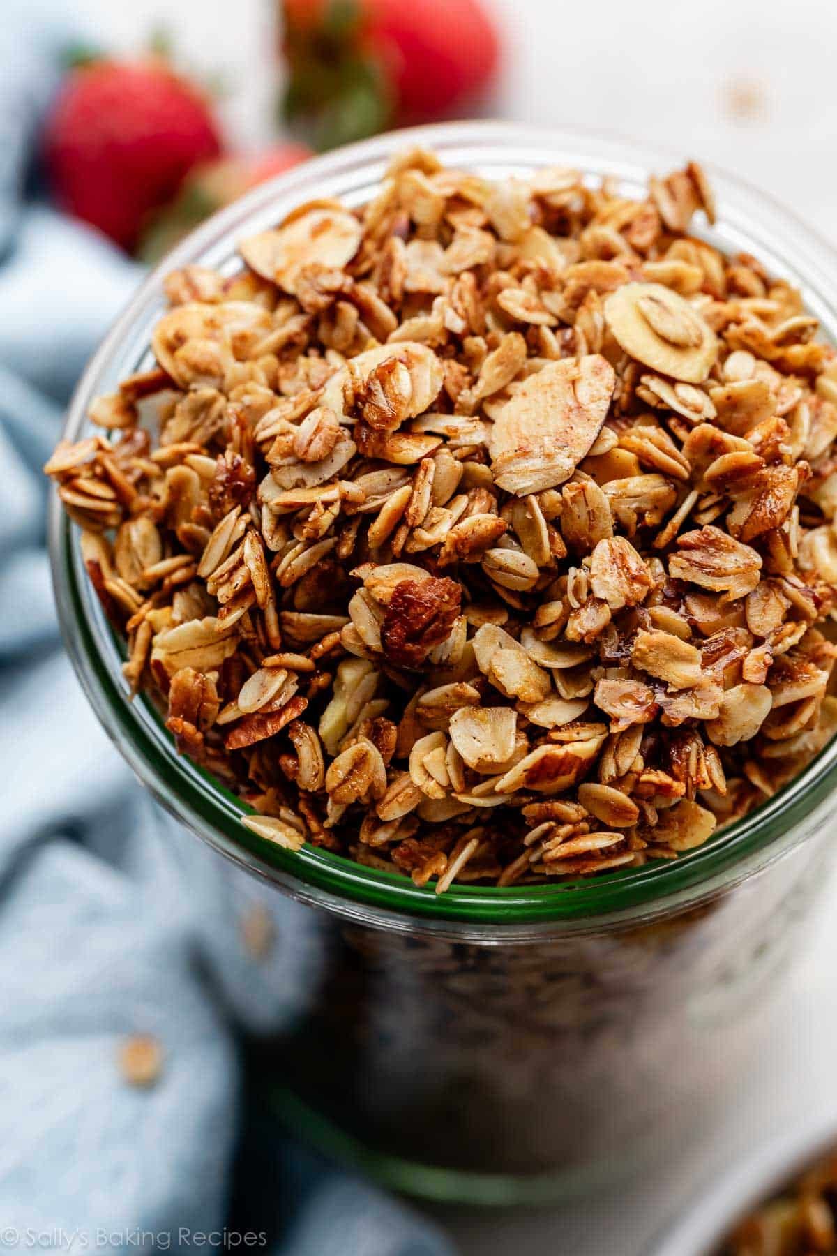 tall jar of vanilla granola with sliced almonds.