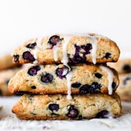 stack of blueberry scones with vanilla icing