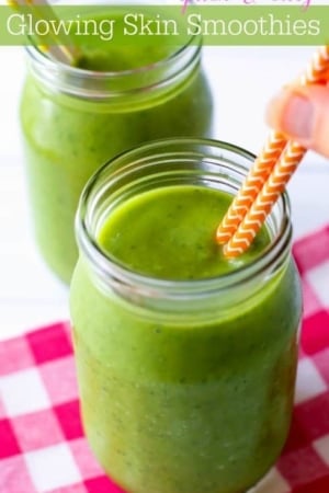 green smoothie in glasses with straws