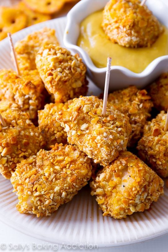 pretzel crusted chicken bites on a white plate