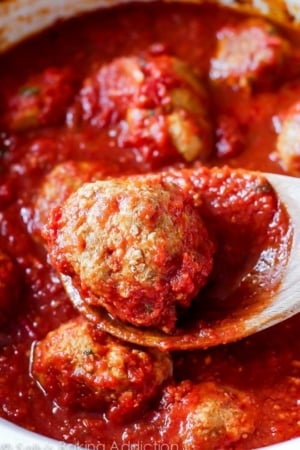 turkey meatball on a wood spoon in a crockpot