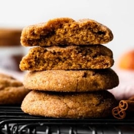 stack of pumpkin snickerdoodles on black cooling rack.