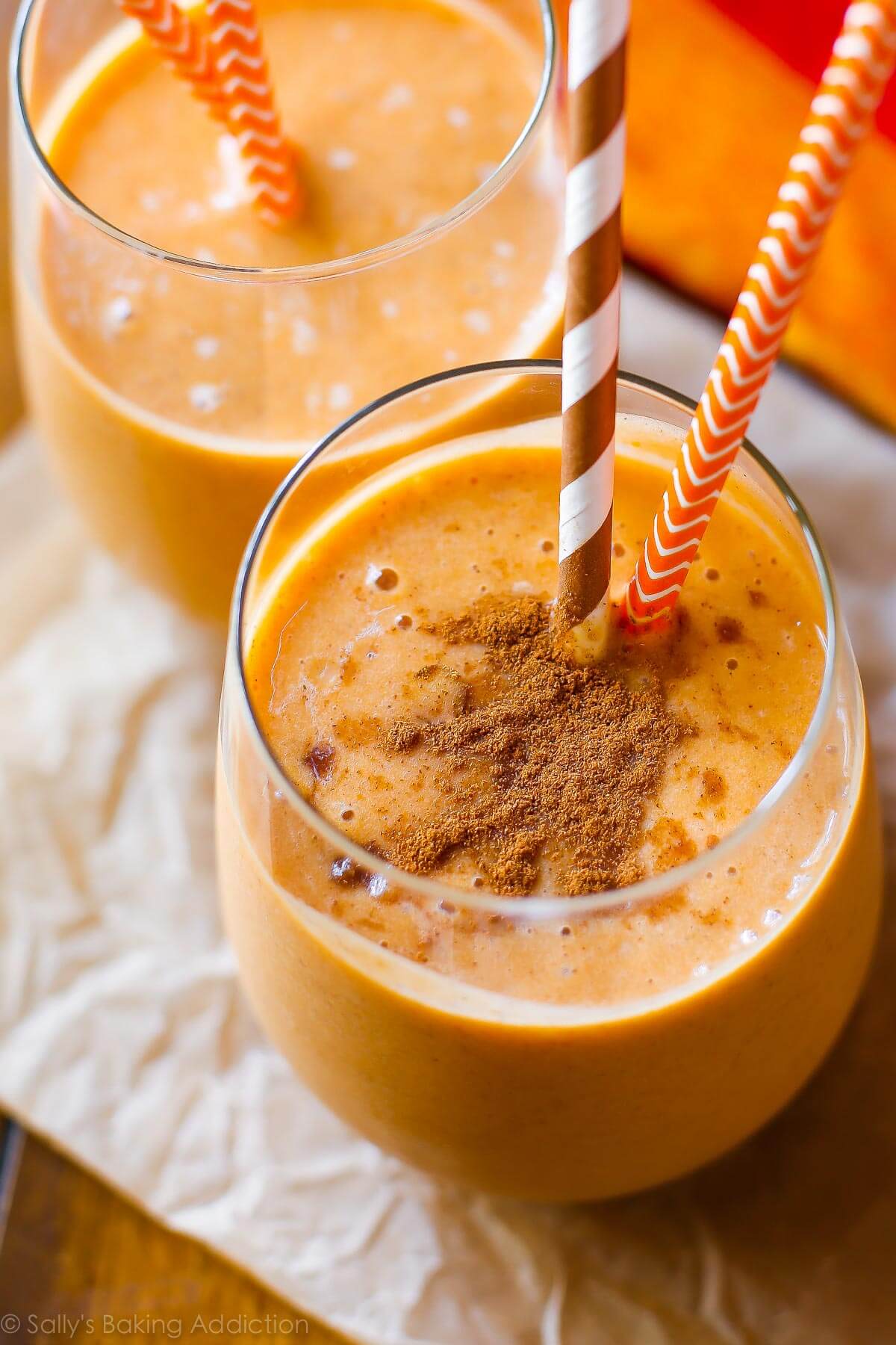 pumpkin protein smoothie in glass cups with straws