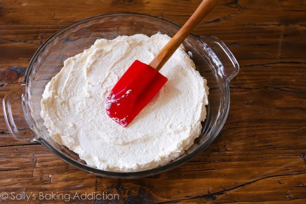 spreading cream cheese mixture into bottom of a glass baking dish