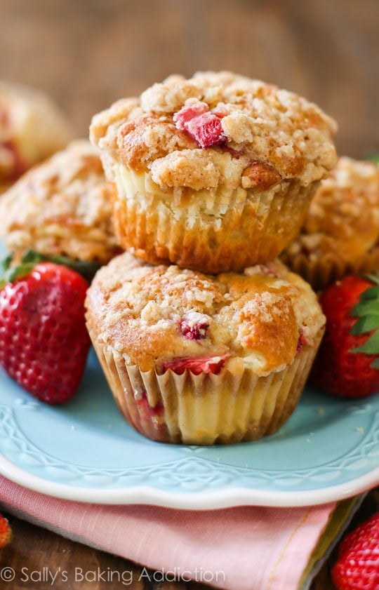 stack of strawberry cheesecake muffins on a blue plate