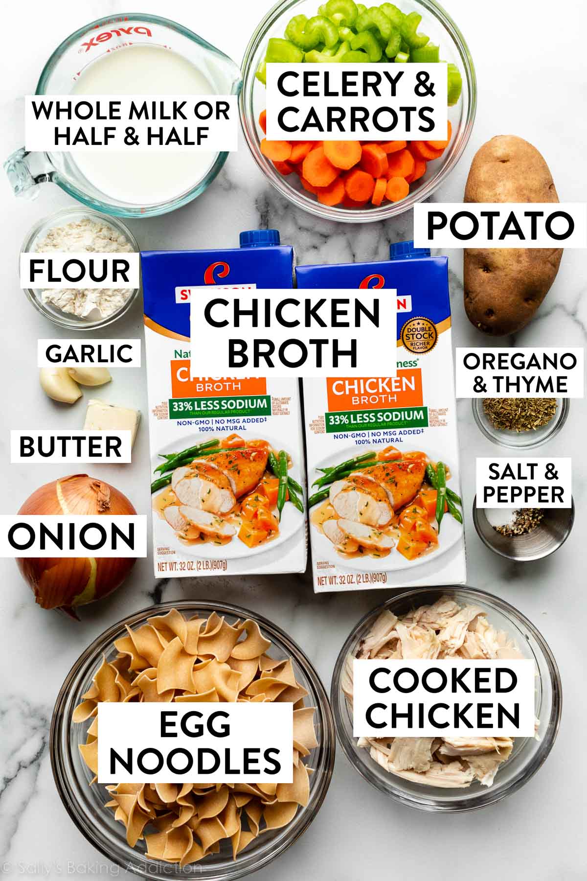 chicken broth, cooked chicken, noodles, carrots, celery, milk, and other ingredients on marble counter.