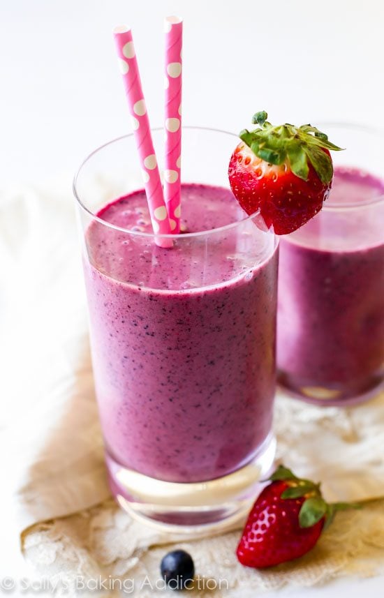 berry smoothies in glasses with straws