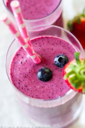 berry smoothies in glasses with straws