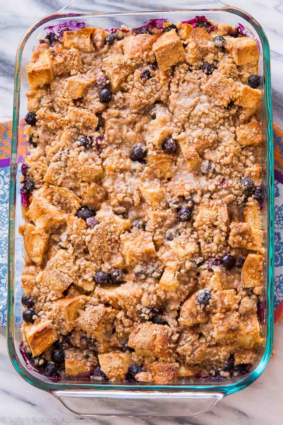 overhead image of blueberry french toast casserole in glass baking dish after baking