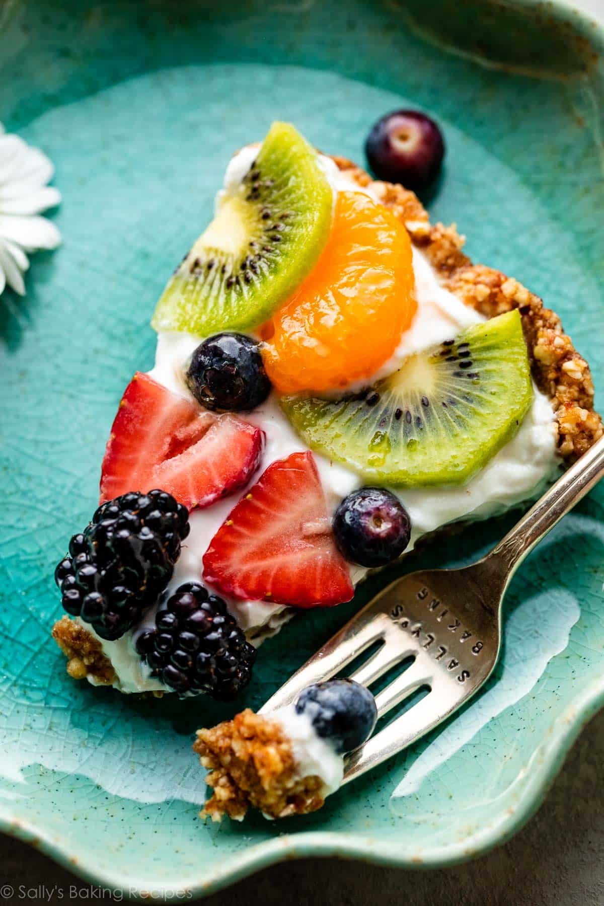 slice of no bake fruit tart on blue plate.