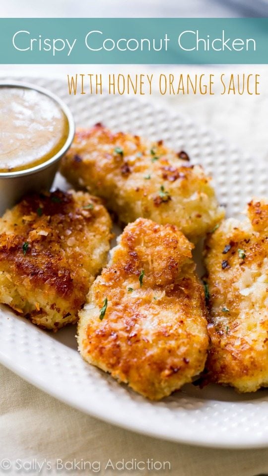 coconut chicken on a white plate with dipping sauce