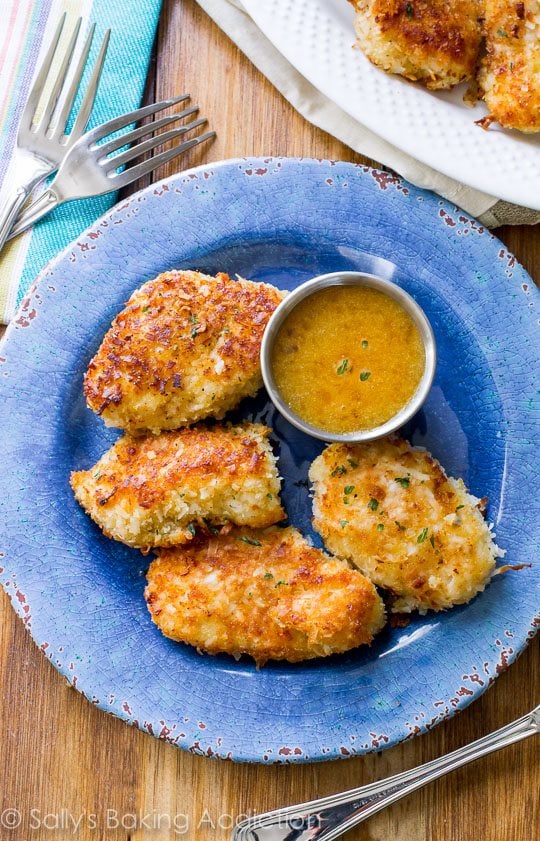 coconut chicken on a blue plate with dipping sauce