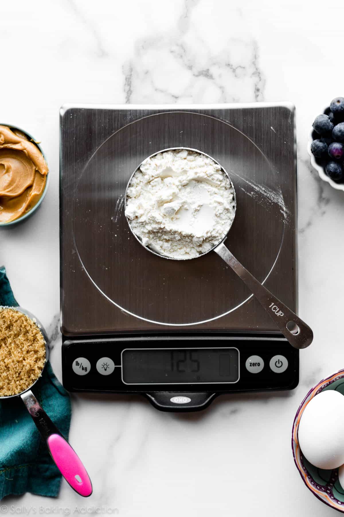 measuring flour on the kitchen scale