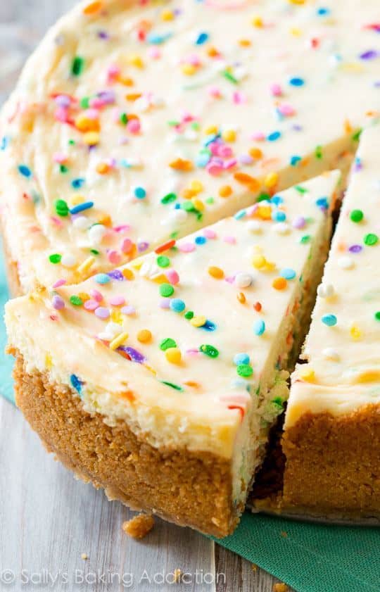 funfetti cheesecake with a slice cut out and pulled away from the full cheesecake