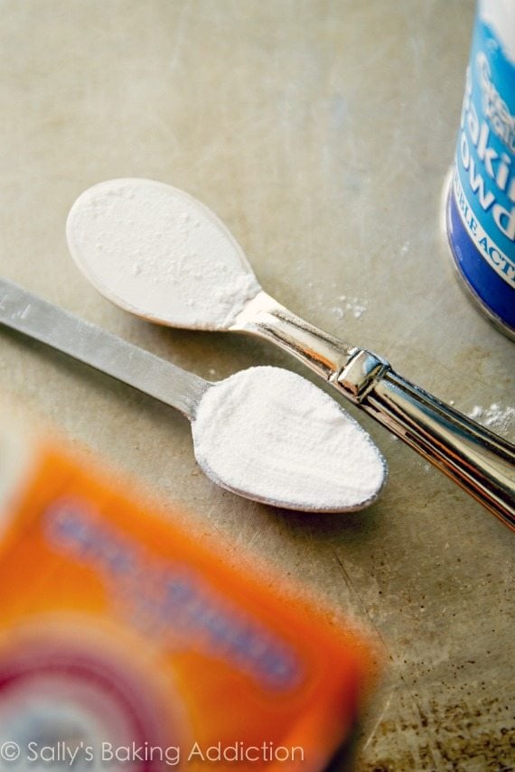 teaspoons of baking powder and baking soda on a baking sheet