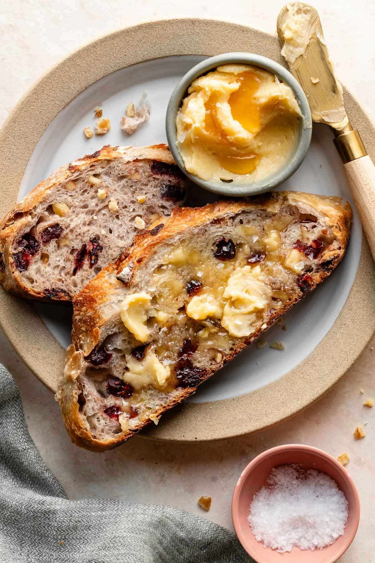 cranberry walnut bread slices with honey butter.