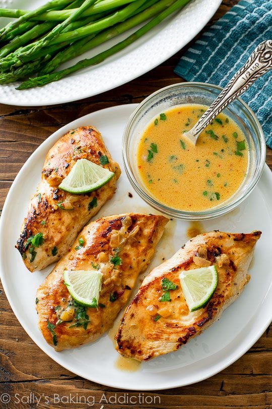 overhead image of chicken with creamy cilantro lime sauce on a white plate