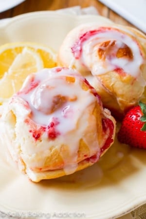 strawberry sweet rolls with lemon glaze on a cream plate