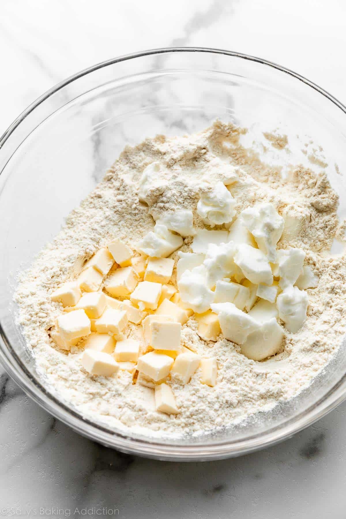 cubes of butter and chopped up shortening in a bowl of flour.