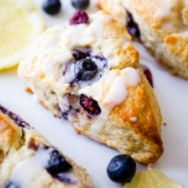 glazed lemon blueberry scones on a white serving tray