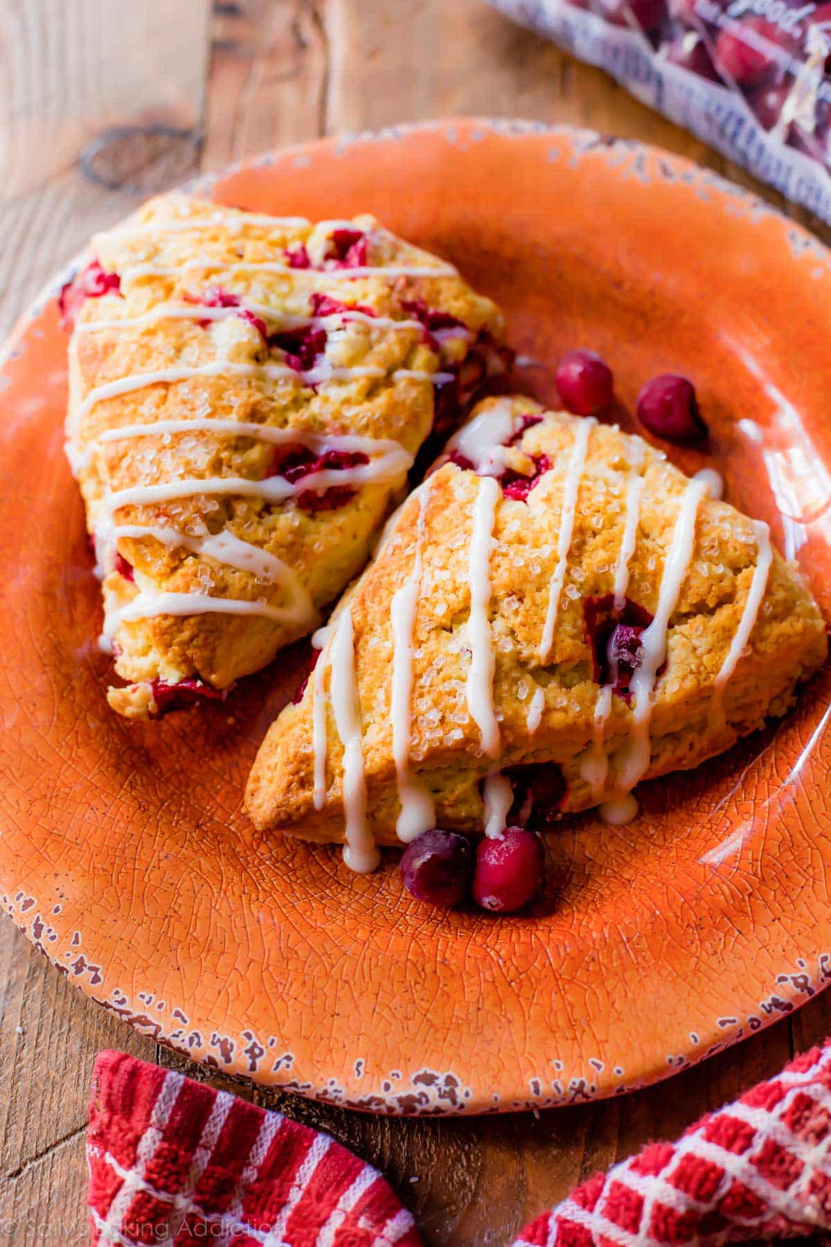 2 cranberry orange scones on an orange plate