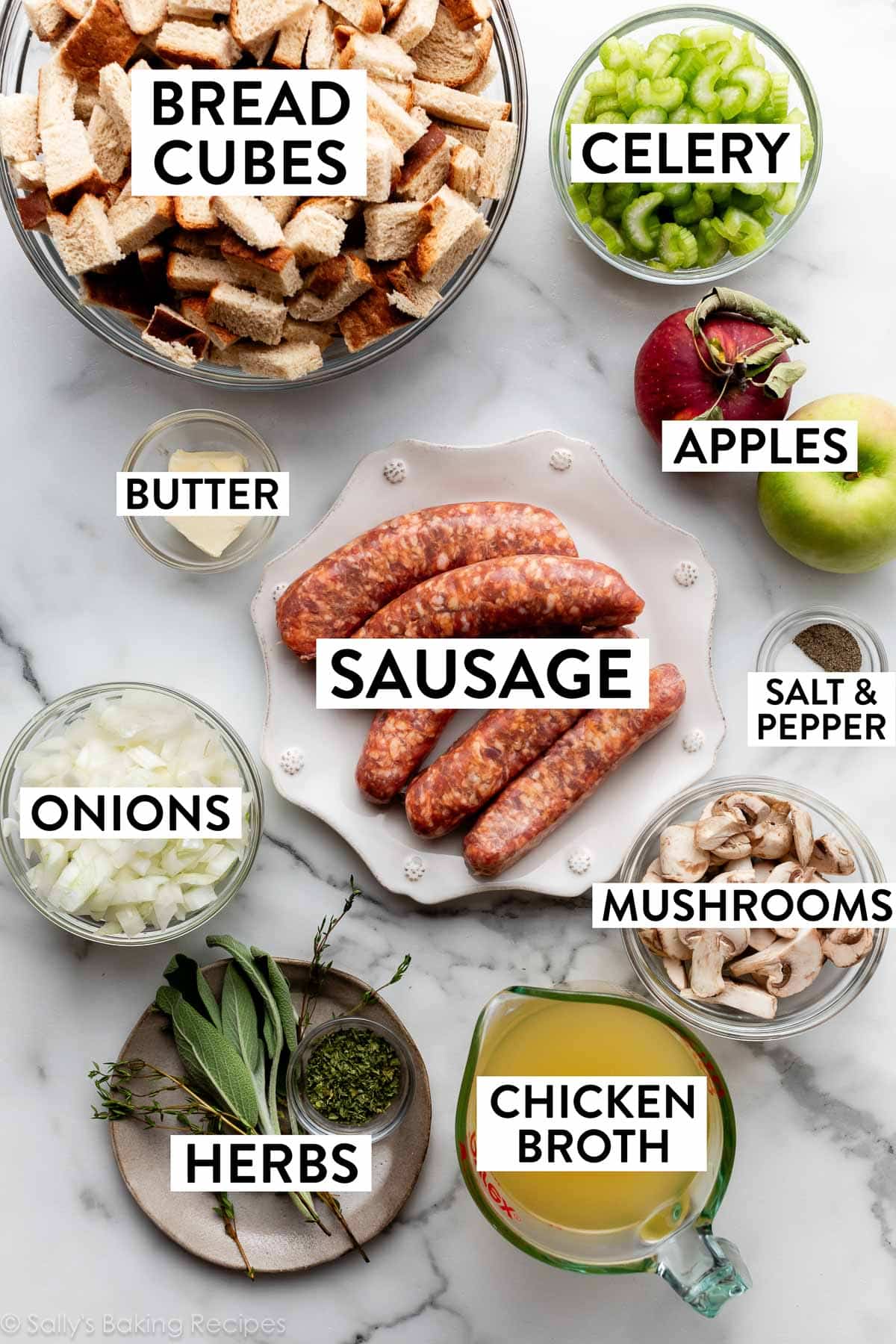 ingredients measured on marble counter including celery, bread cubes, chicken broth, herbs, onions, mushrooms, and butter.