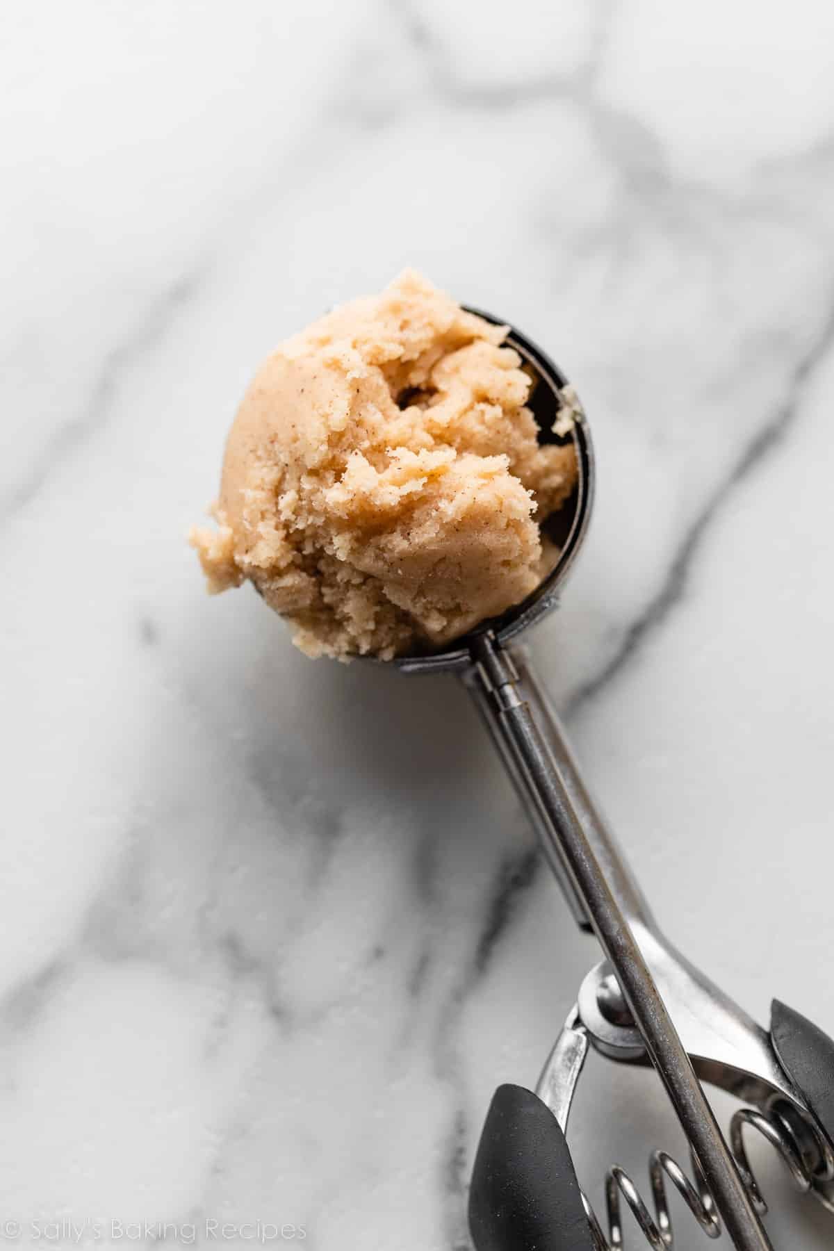 cinnamon cookie dough in cookie scoop.