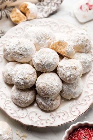 snowball cookies on white plate.