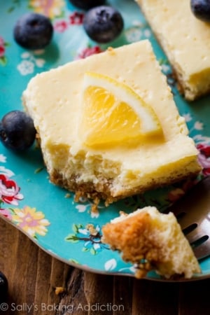 Greek yogurt lemon bars on a colorful plate with a fork