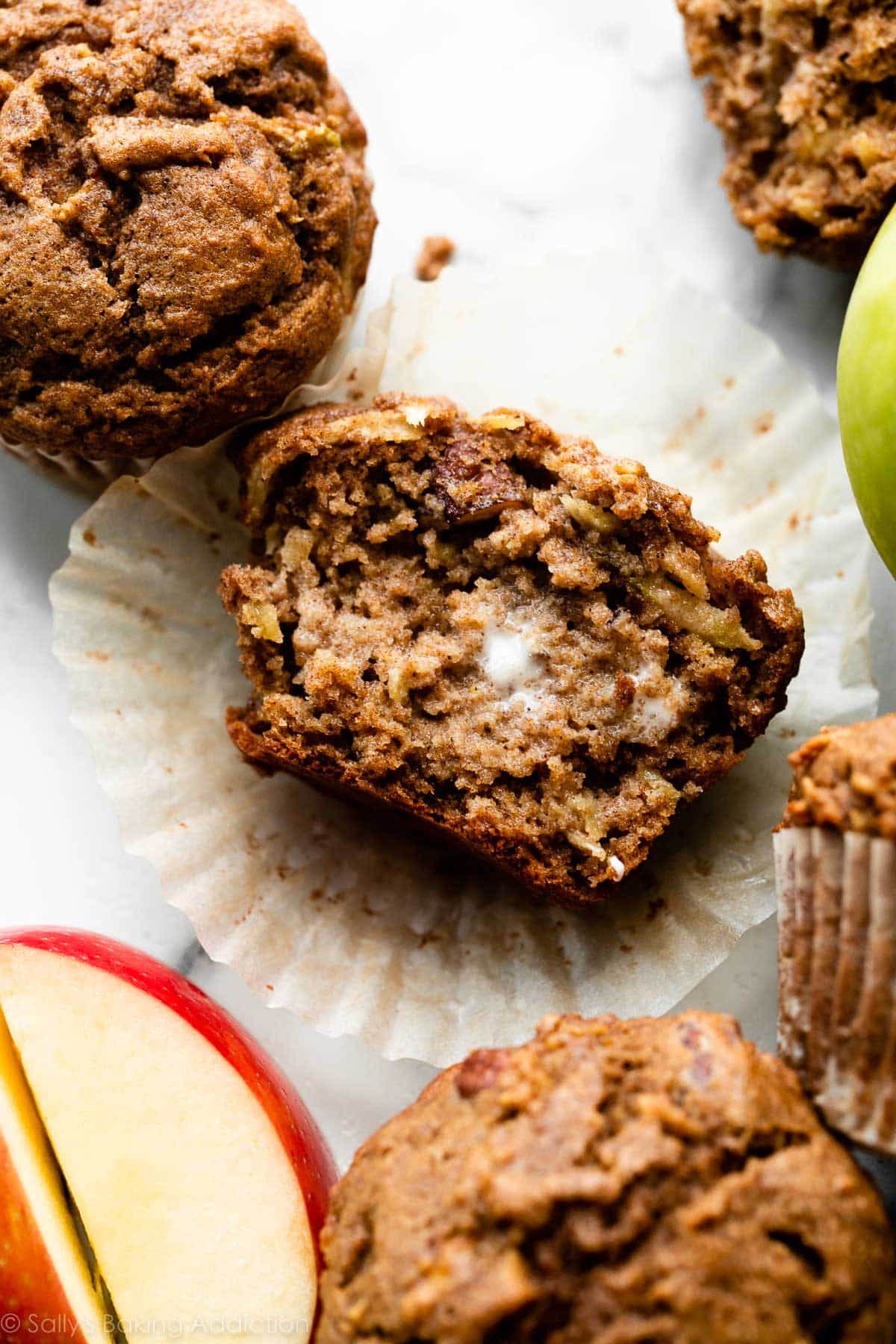 apple muffin split in half with butter melting on top.